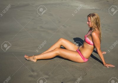 62215919-young-girl-in-red-bikini-and-image-of-heart-on-sand-on-beach-of-crete-in-greece